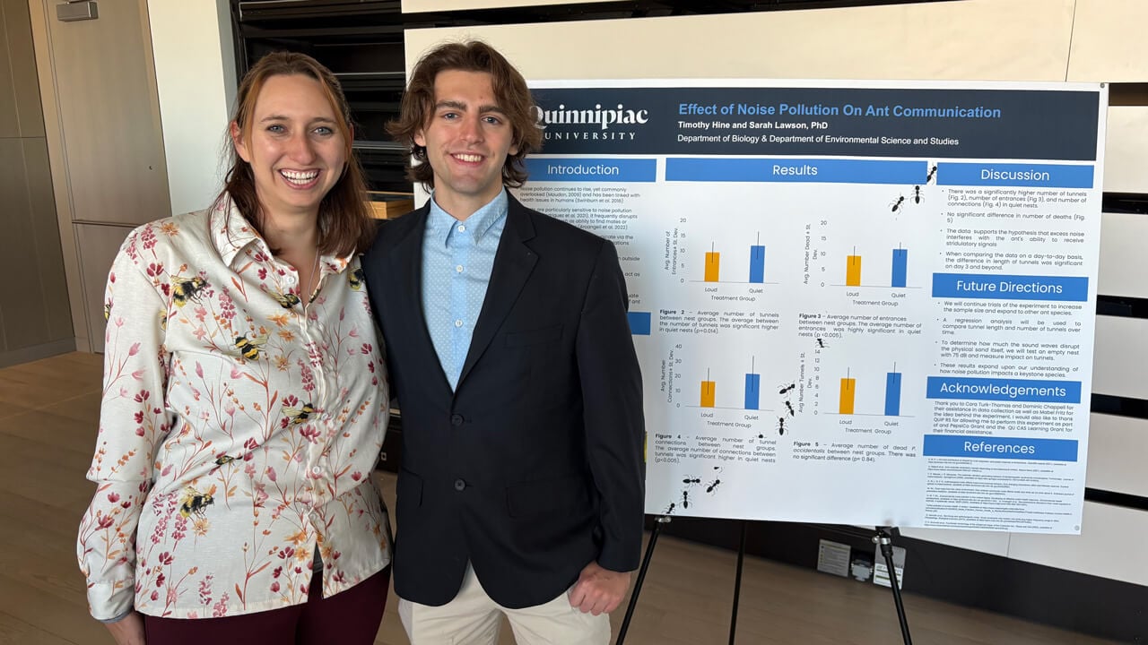 Sarah Lawson and Timothy Hine posing with their poster