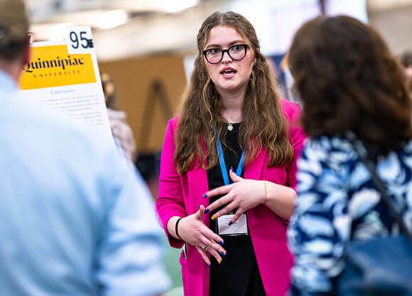 Student presenting their capstone project at the symposium