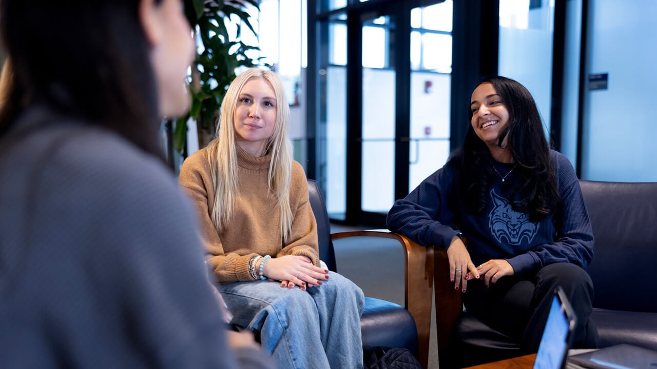 2 female students talk to someone off camera