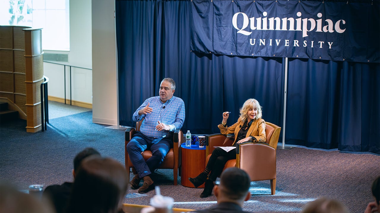 Quinnipiac President Judy Olian and JetBlue CEO Robin Hayes sit in armchairs and talk