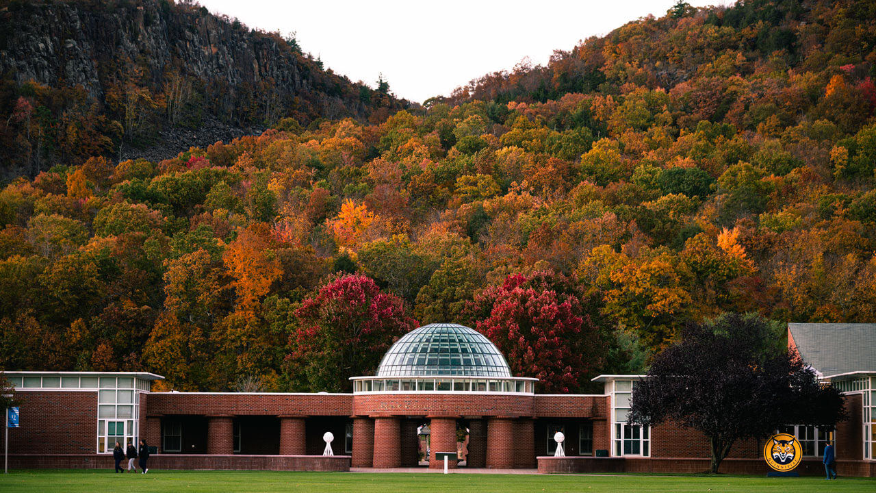 Sleeping Giant fall foliage behind the school of business dome.