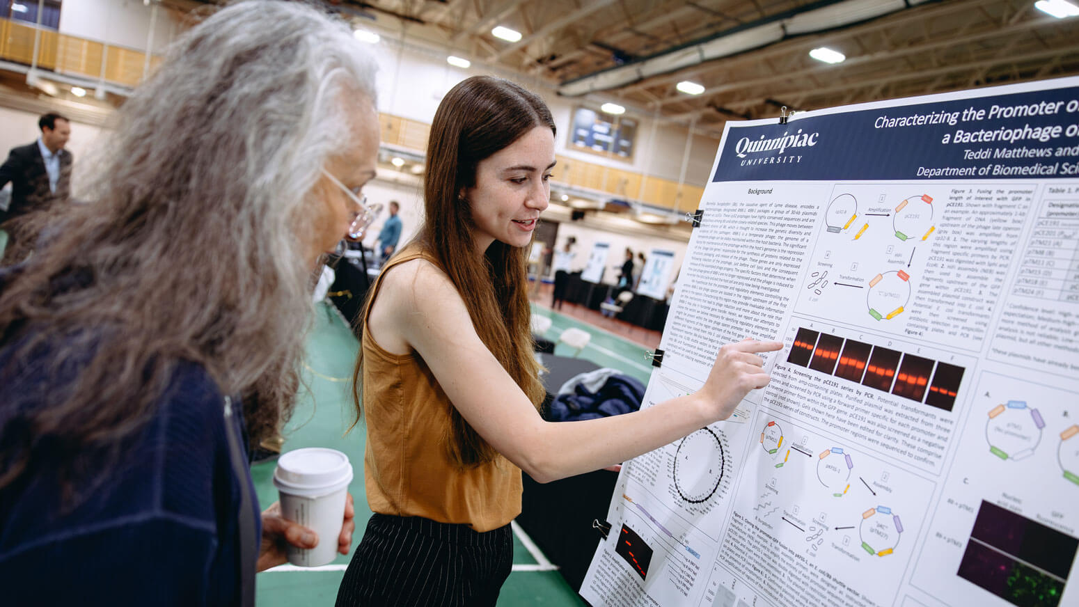 A student presents her project to an exploratorium attendee during Bobcat Weekend.